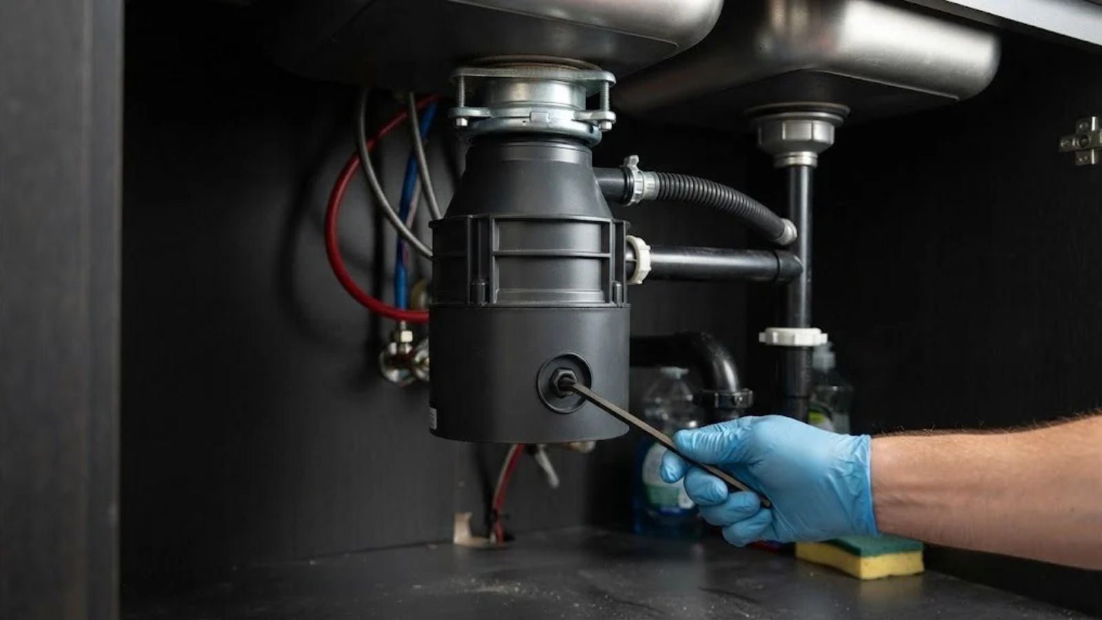 Garbage disposal repair under a kitchen sink in Denton, TX
